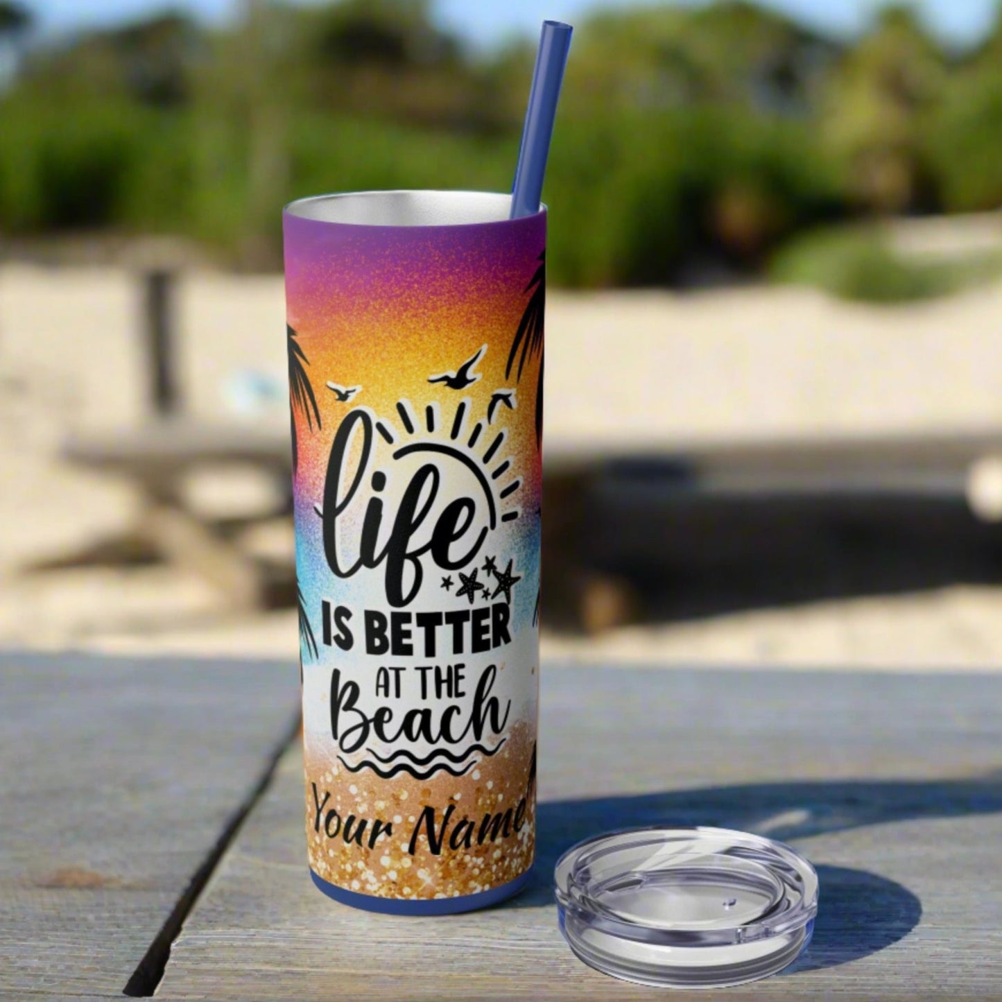 skinny 20 oz tumbler with vibrant design of beach with text life is better at the beach