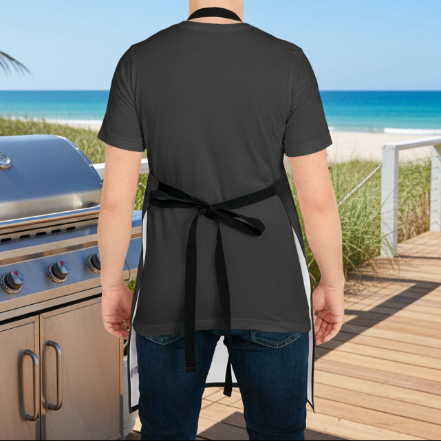Person wearing a black apron in a kitchen setting
