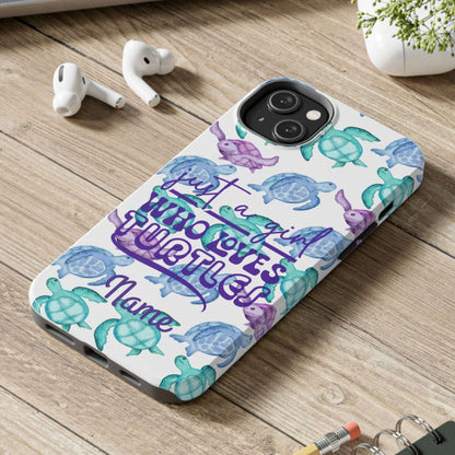 Phone case with sea turtle design on a wooden surface with laptop, earbuds, and notebook.