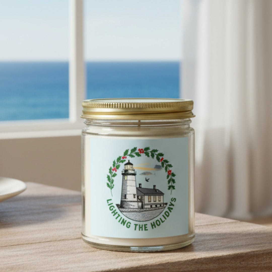 Candle jar with a lighthouse design and 'Lighting the Holidays' text on a white background