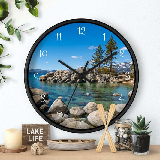 Wall clock with scenic design of a lake and mountains on a white wall.