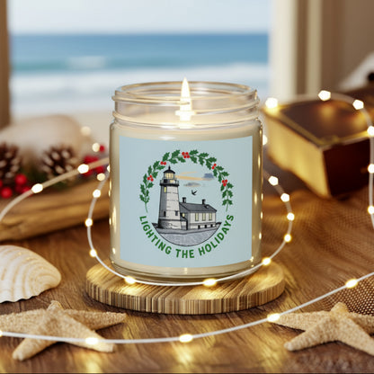 Candle in a jar with a lighthouse design on a wooden coaster with fairy lights.
