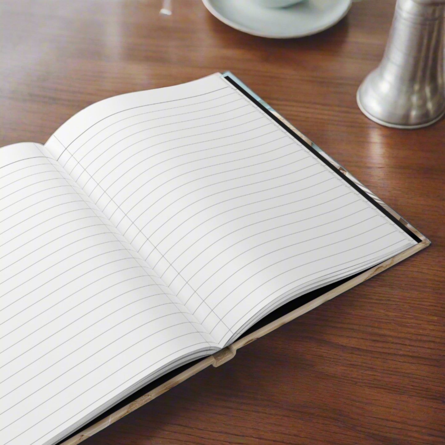 Open hardback journal showing lined pages