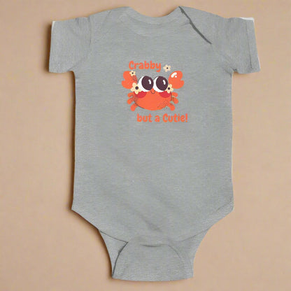 Gray short sleeved body suit with cartoon crab that says crabby but a cutie