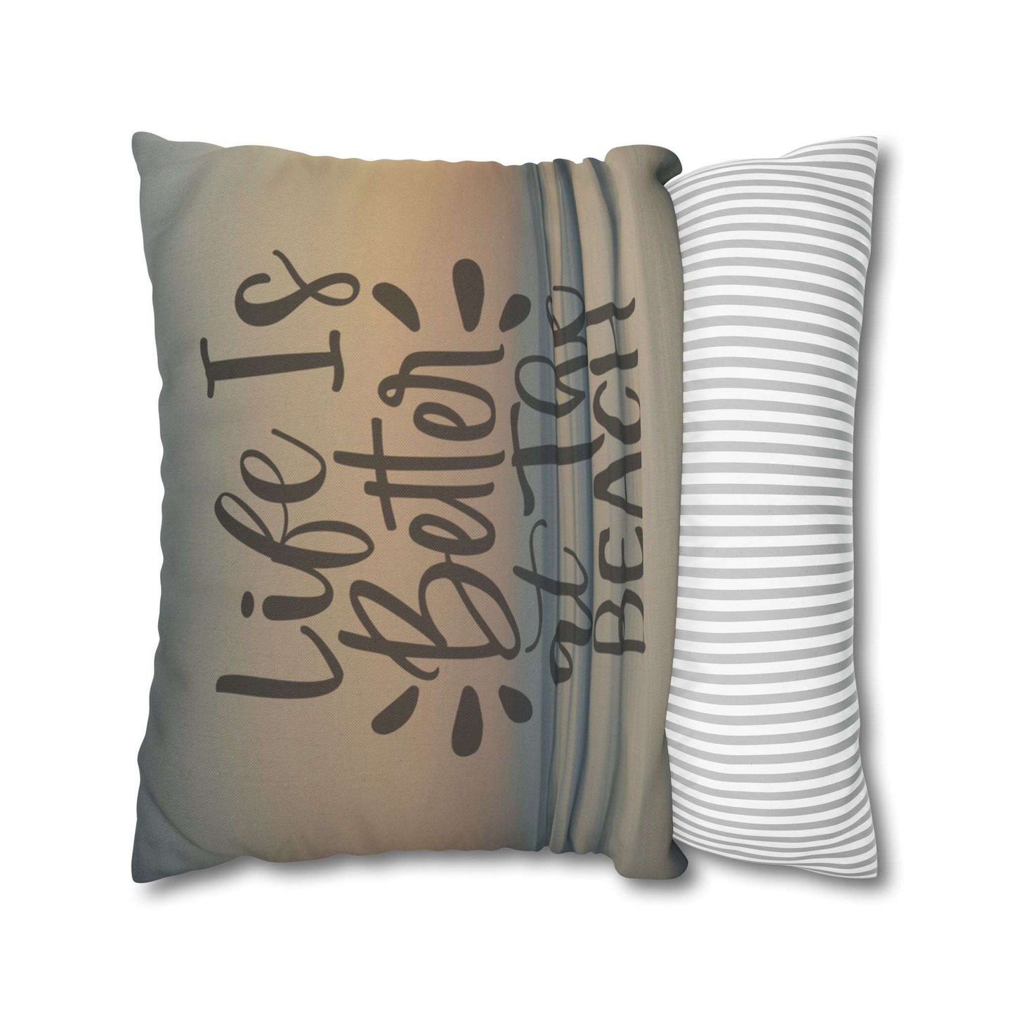 Decorative pillow case with 'Life is Better at the Beach' text and a striped pillow next to it.