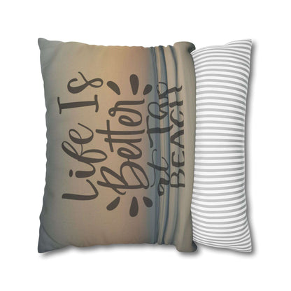 Decorative pillow case with 'Life is Better at the Beach' text and a striped pillow next to it.