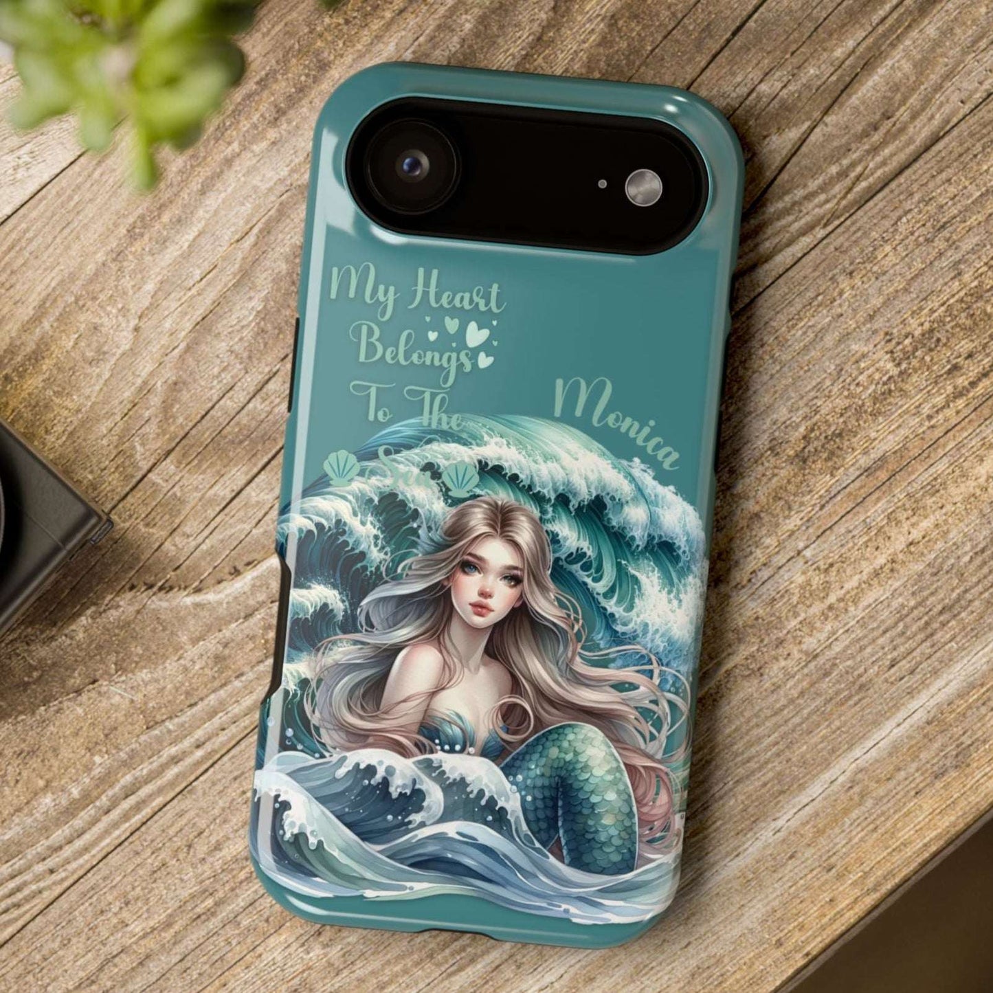 iPhone 17 Air case with mermaid design and text on a wooden surface