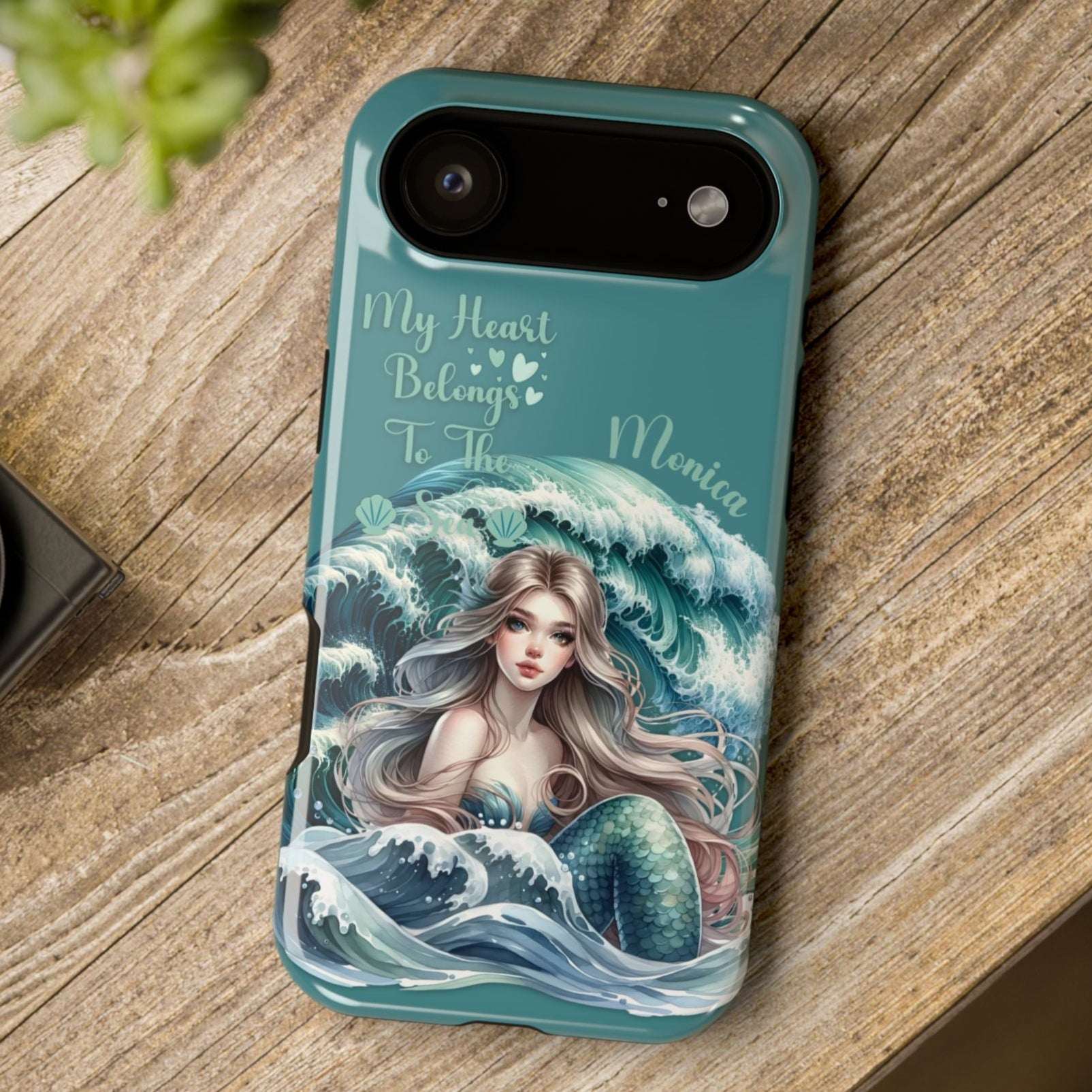 iPhone 17 Air case with mermaid design and text on a wooden surface