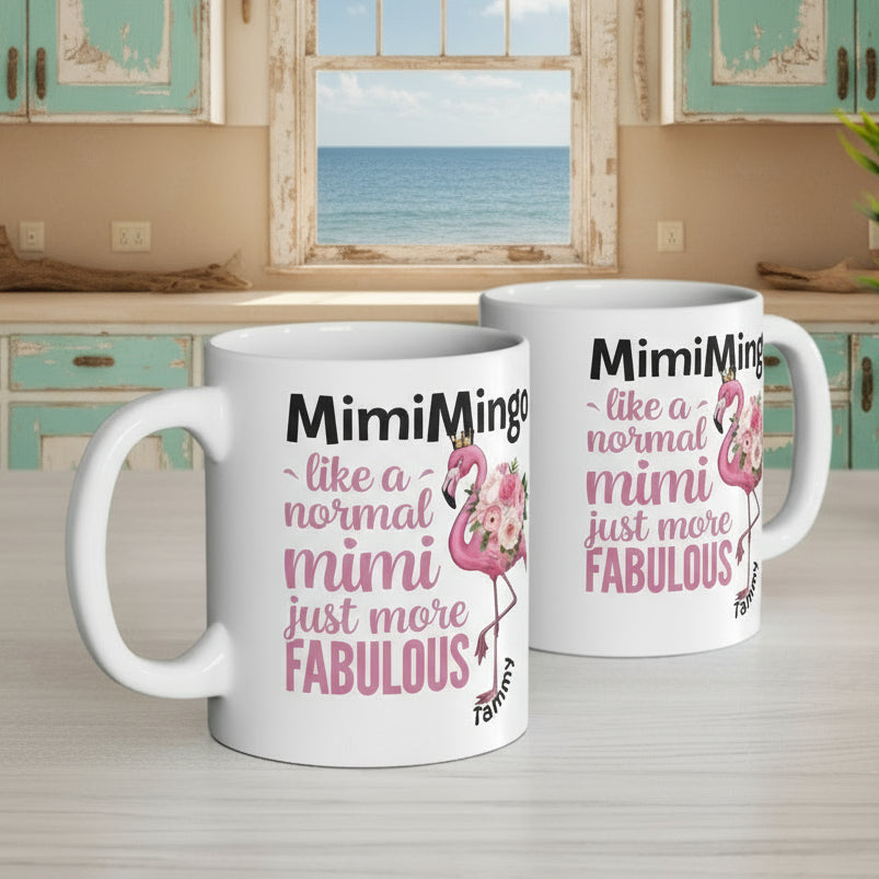 Two mugs with flamingo design and text on a desk with office items.