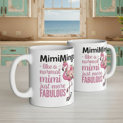 Two mugs with flamingo design and text on a desk with office items.