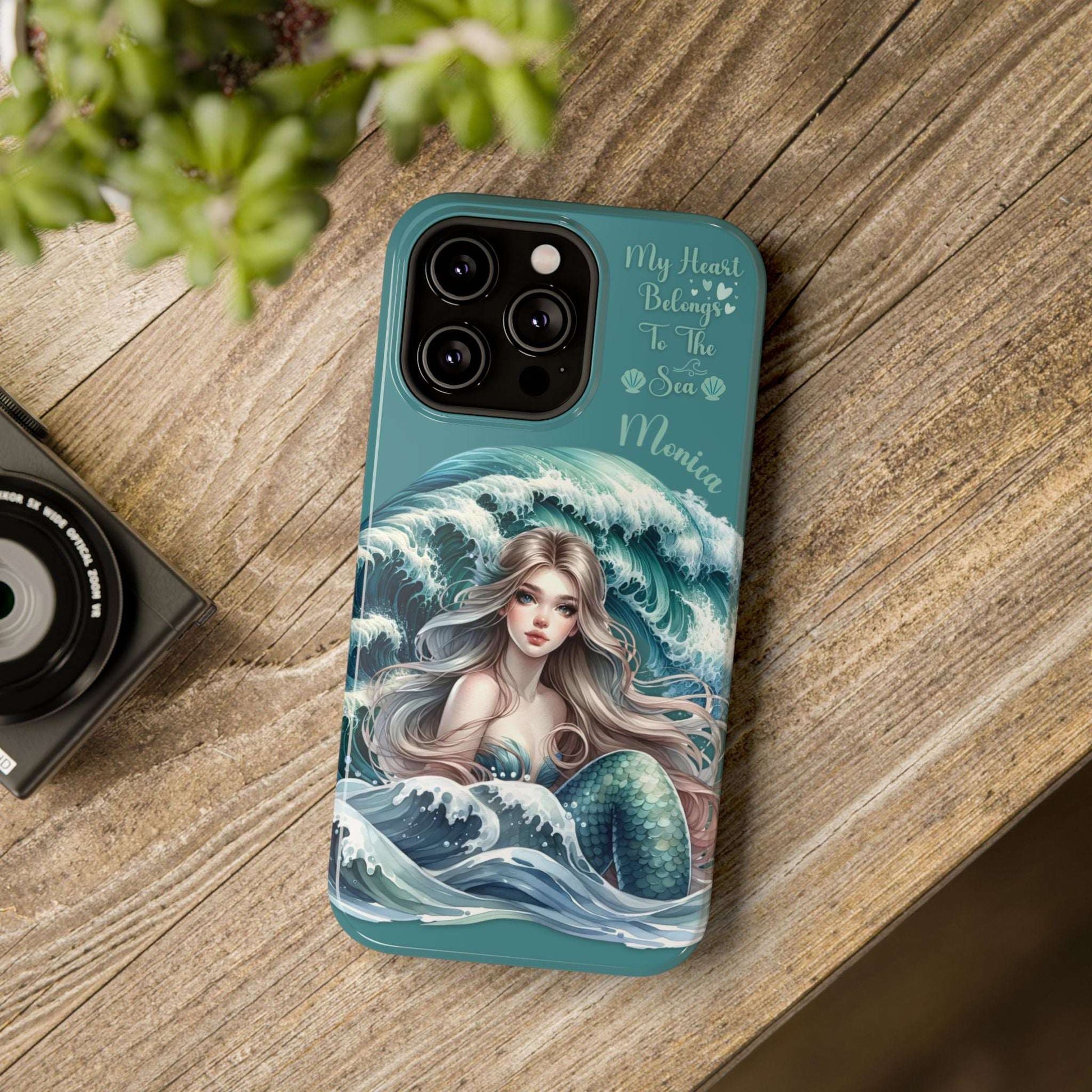 iPhone case with mermaid design on a wooden surface