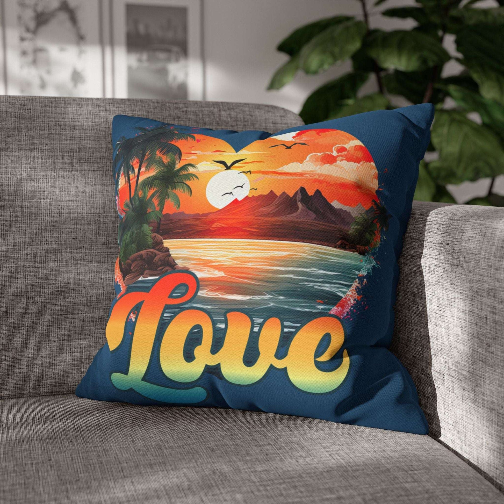 Decorative 18" x 18" blue pillow with a sunset heart design and 'love' text on a gray couch.