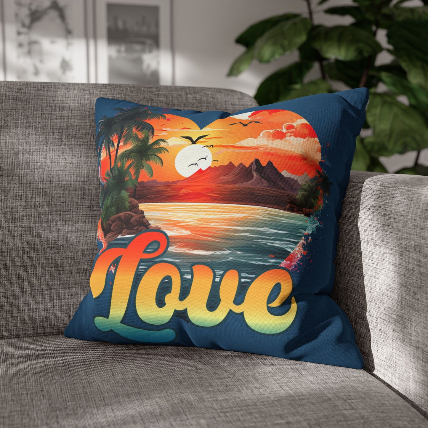 Decorative 18" x 18" blue pillow with a sunset heart design and 'love' text on a gray couch.