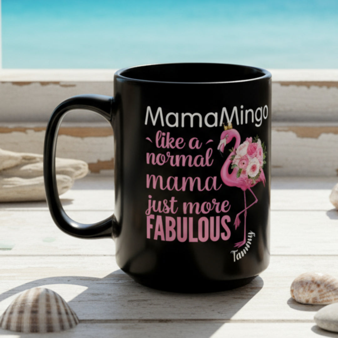 Black mug with pink and white text and flamingo design on a white background