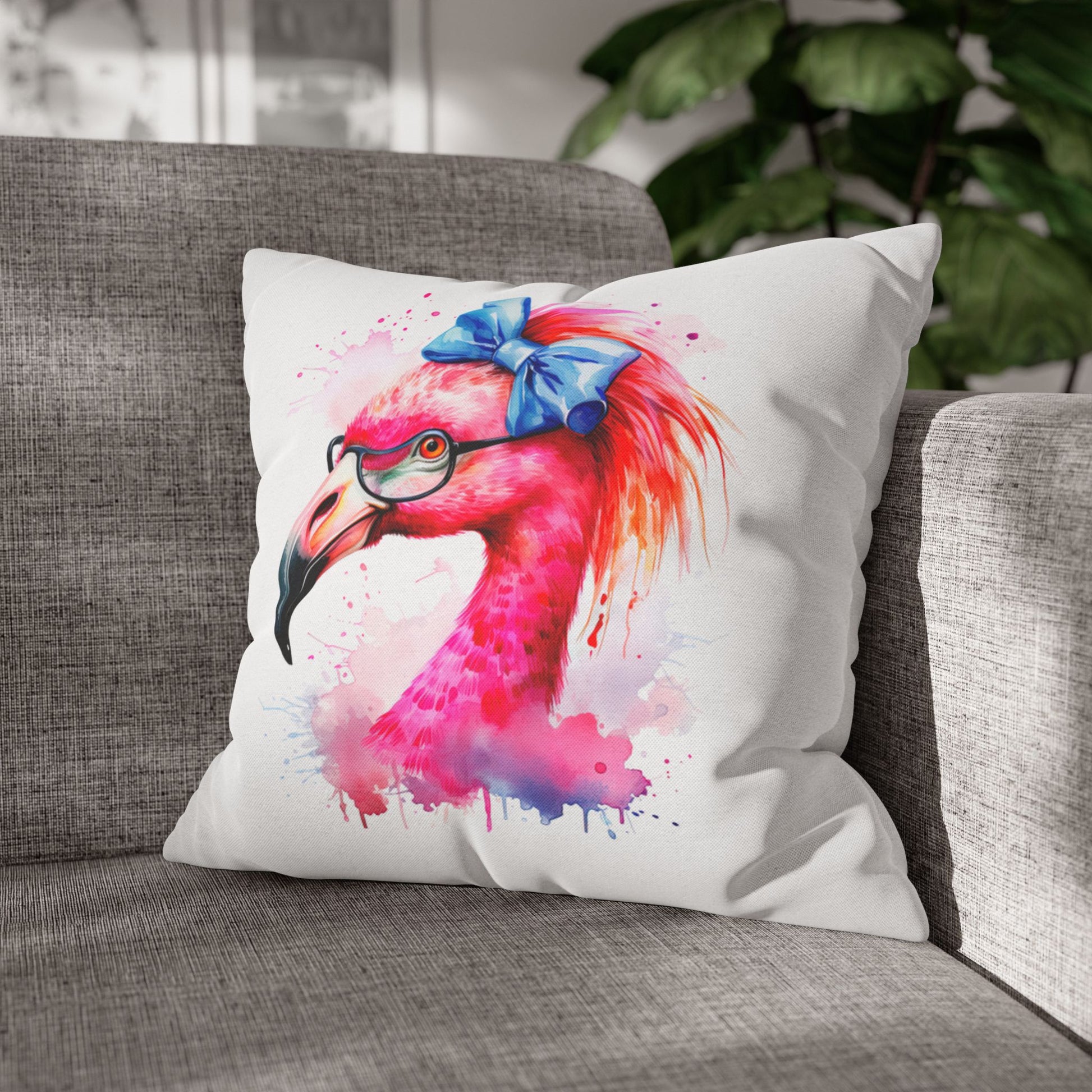 Decorative square pillowcase featuring a flamingo head wearing glasses and a big blue bow on a white background.