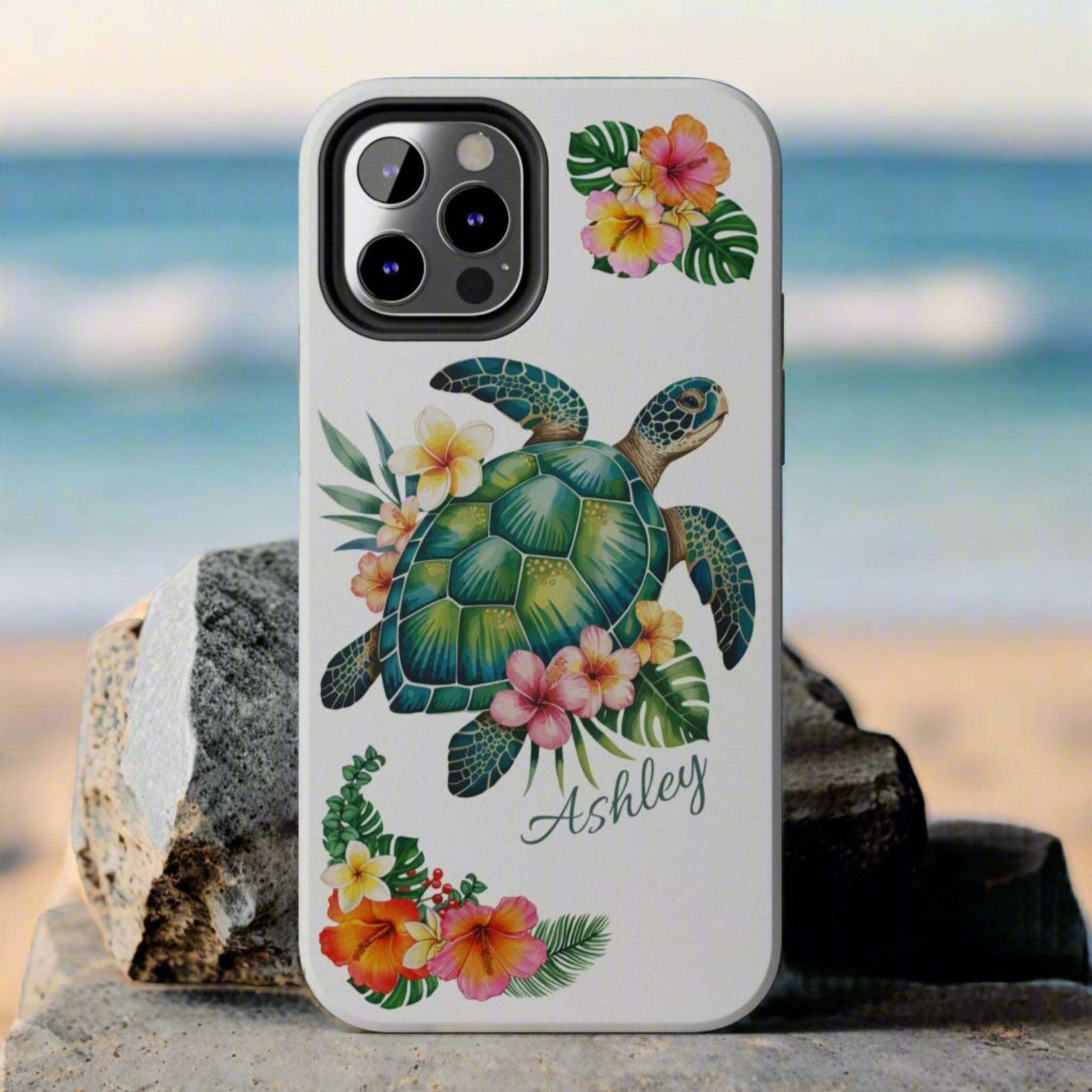 iPhone 12 case with a white background and a sea turtle with hibiscus flowers, with more hibiscus flowers around the sides.