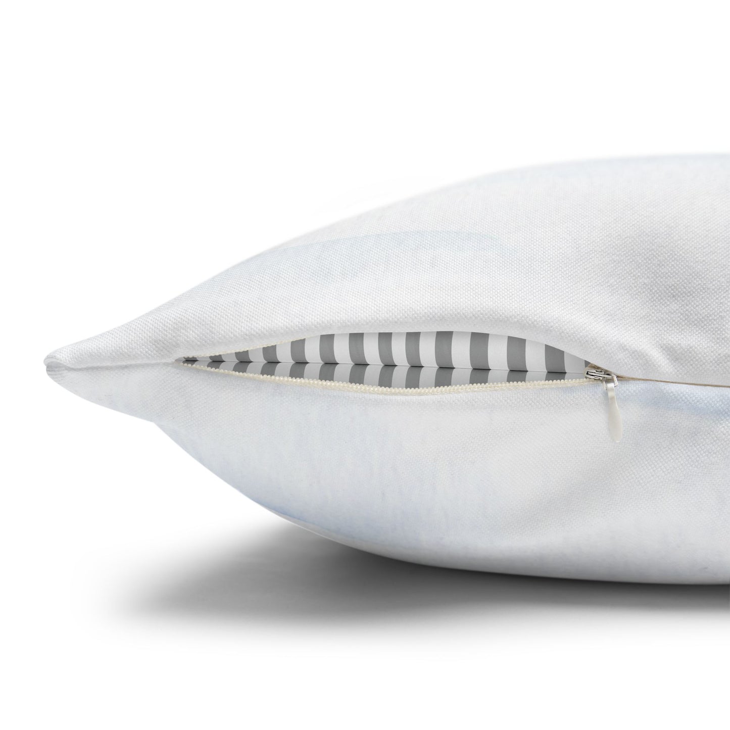 White pillow with a striped interior on a white background