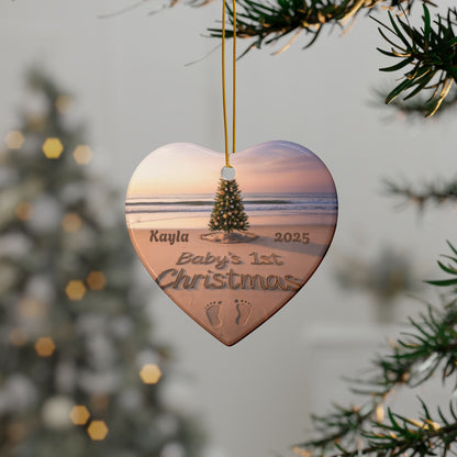 Heart-shaped ornament with a beach scene and engraved text, hanging on a tree.
