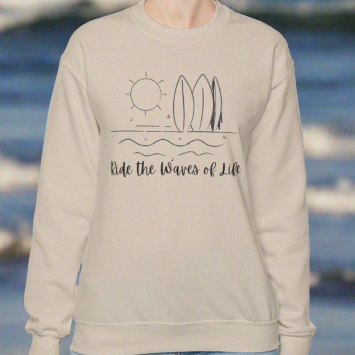 Sand crewneck sweatshirt with waves, surfboards and sun with the words Ride the Waves of Life