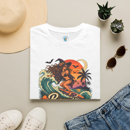 Folded white unisex t-shirt with “Beach Witch Energy” text, a witchy surfer girl, ocean wave, sunset, crescent moon, bats, palm trees, and tropical flowers.