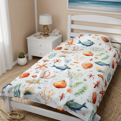 Bed with a colorful sea-themed blanket in a bedroom setting.