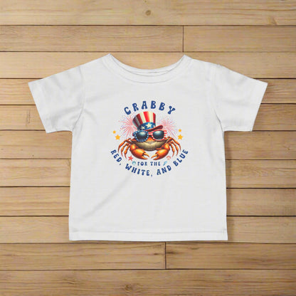 White Infant t-shirt with a crab wearing an American flag top hat surrounded by fireworks and seashells with the phrase “Crabby for the Red, White, and Blue.”