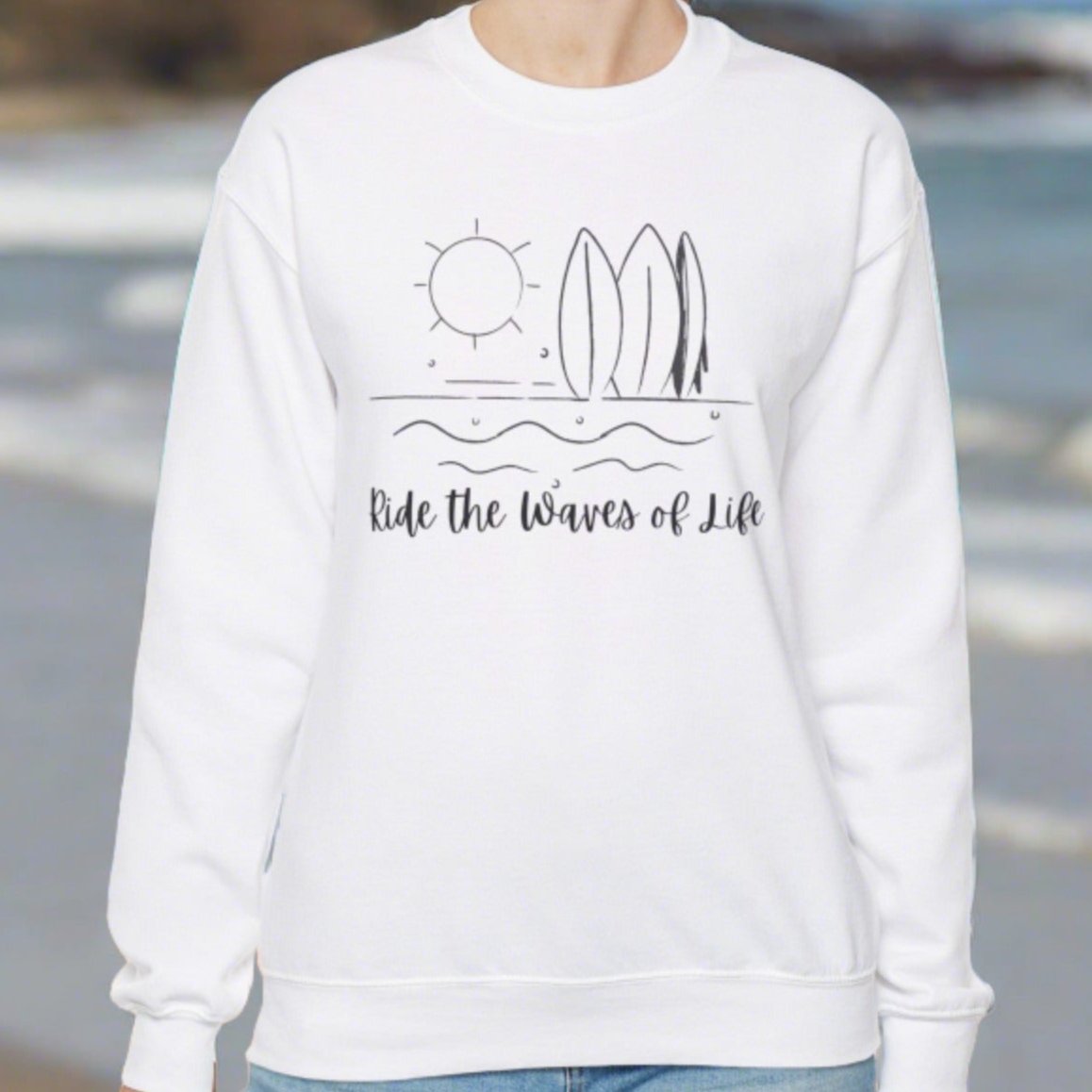 Whitecrewneck sweatshirt with waves, surfboards and sun with the words Ride the Waves of Life