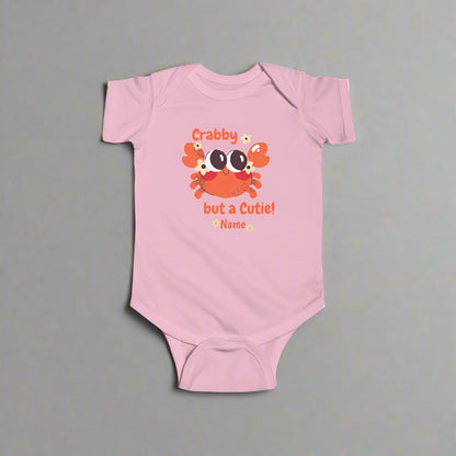 Light Pink short-sleeved bodysuit with cartoon crab that says crabby but a cutie with a space for a personalized name below.