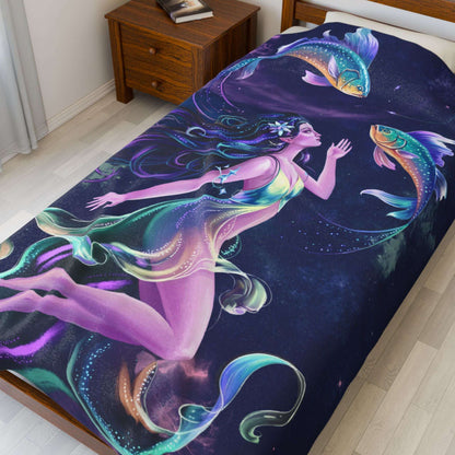 Velveteen blanket with a colorful mermaid design on a bed in a room.
