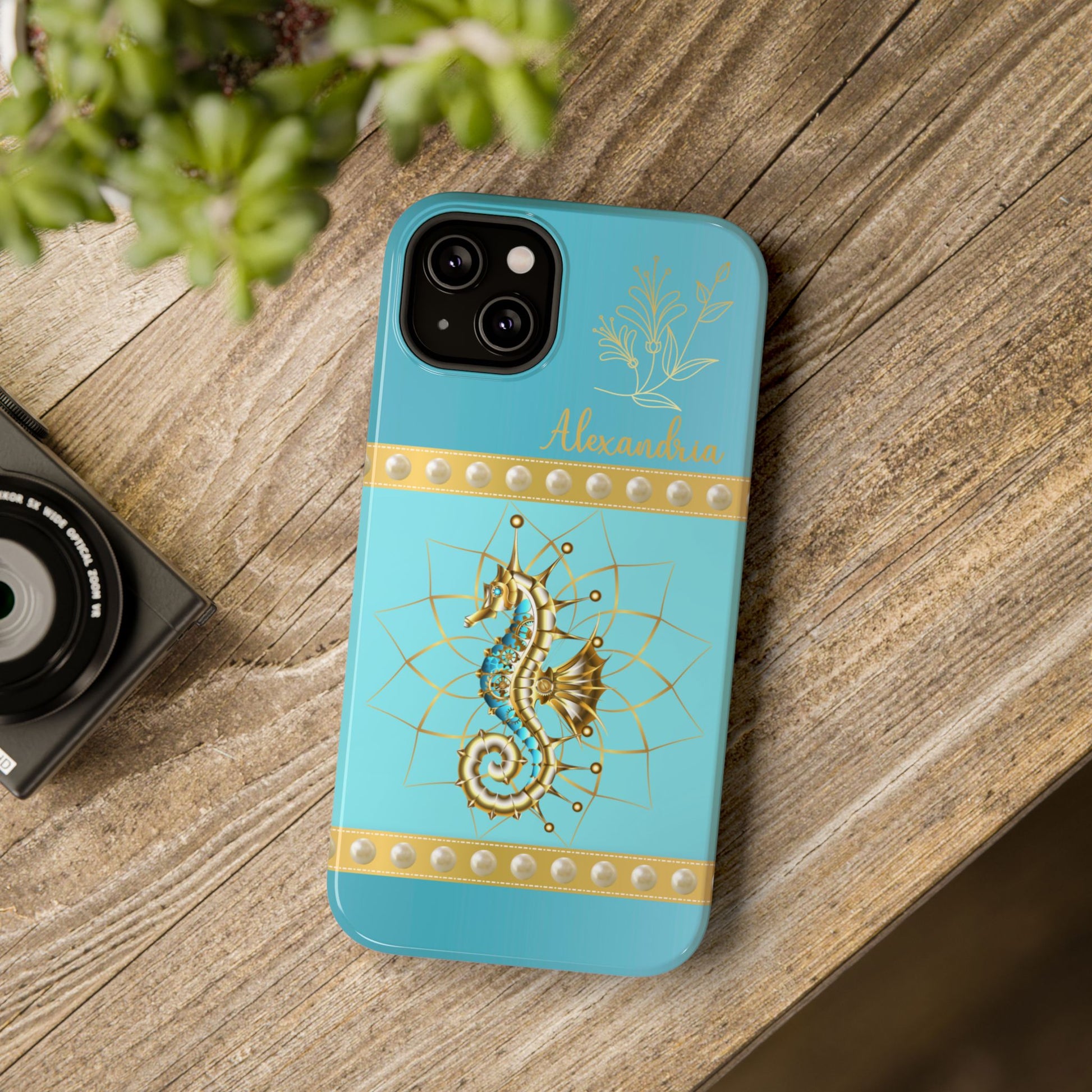 Phone case with seahorse design and 'personalized' text on a teal blue background.