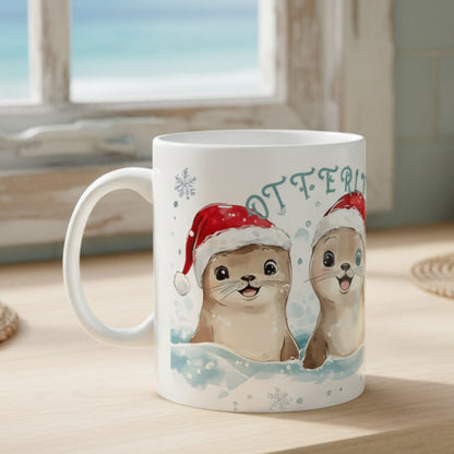 White mug with cartoon otters wearing Santa hats and the word 'OTTERLY' on a white background.