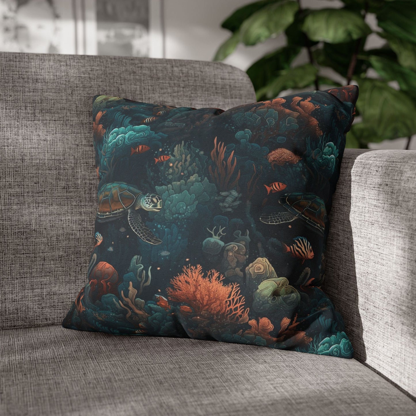 18" x 18" Decorative pillow with underwater scene with sea turtles on a gray couch.