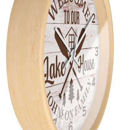 Wall clock with 'Welcome to our Lake House' text and wooden design on a white background