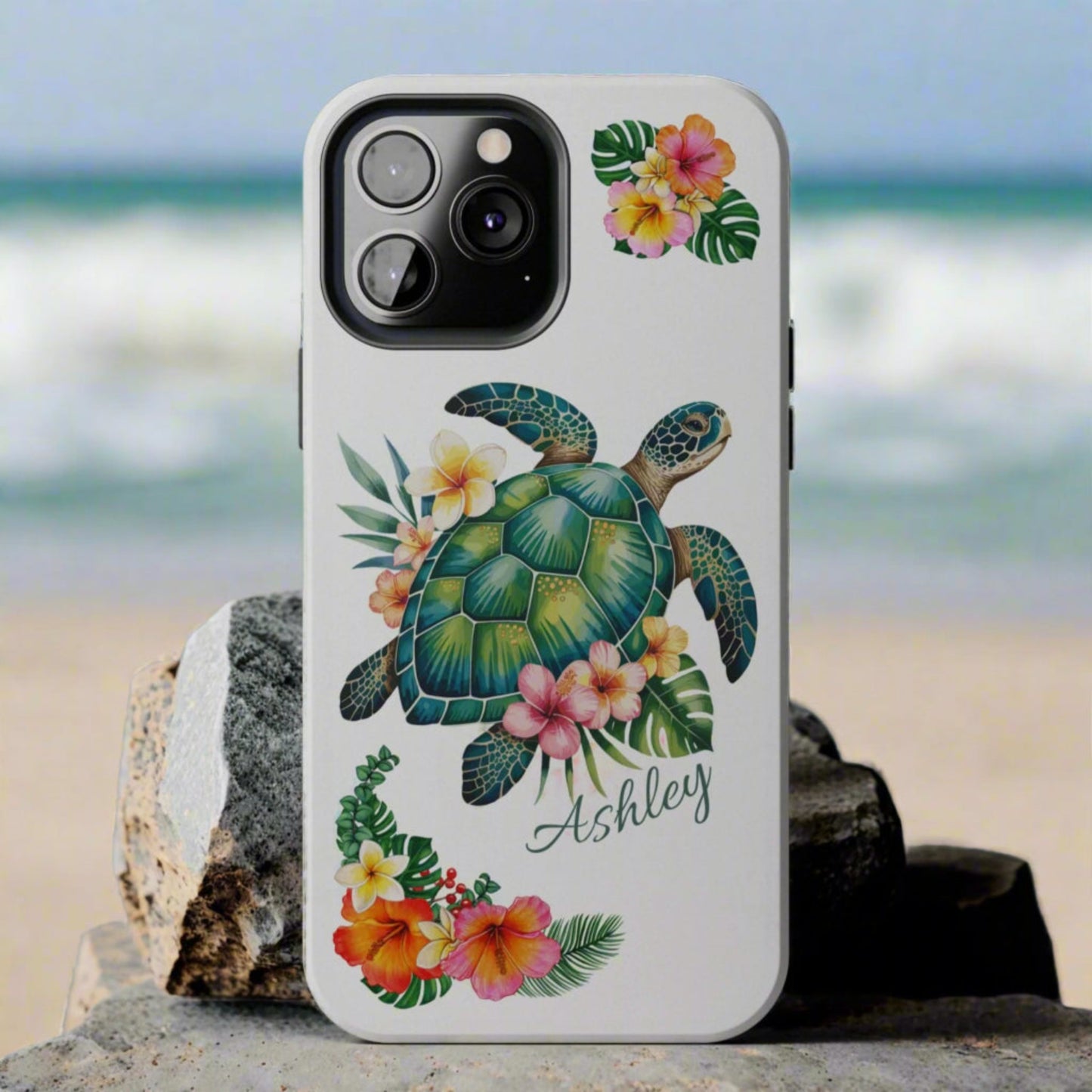 iPhone 11 case with a white background and a sea turtle with hibiscus flowers, with more hibiscus flowers around the sides.