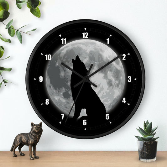 Wall clock with a wolf howling at the moon design on a white wall.