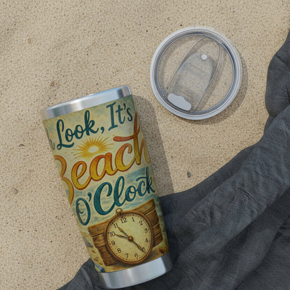 Tumbler with 'Look, It's Beach O'Clock' design on the sand.