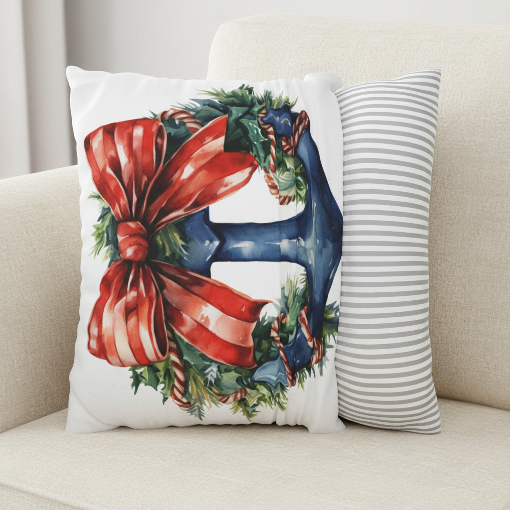Decorative pillow with a Christmas design featuring a red bow and greenery on a blue anchor.