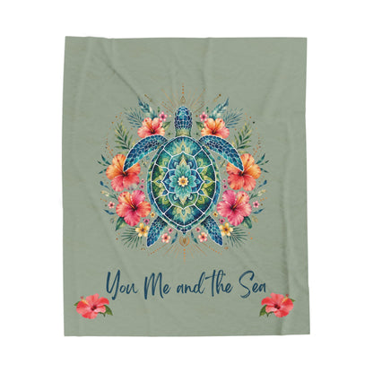 Ultra-soft plush 60x80" blanket featuring a vibrant mandala sea turtle surrounded by tropical hibiscus flowers with the phrase "You, Me and the Sea" on a sage-green background.