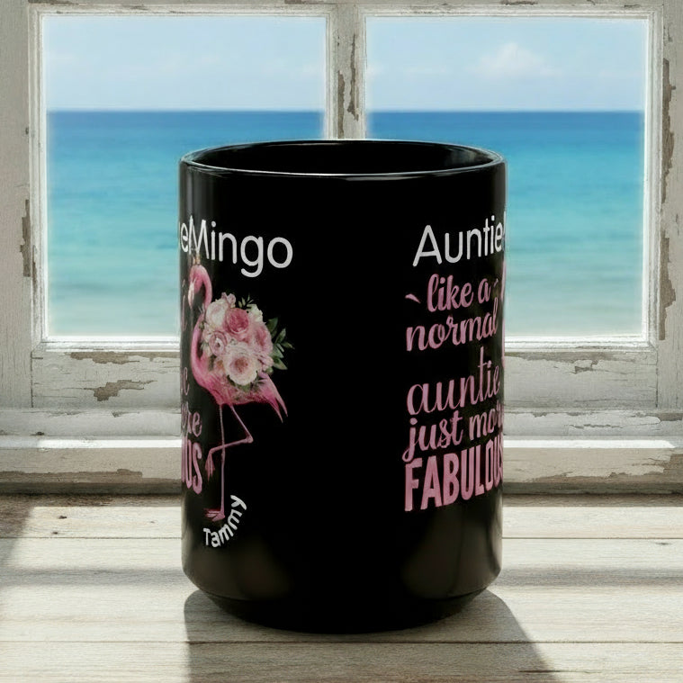 Black mug with pink flamingo and text on a white background