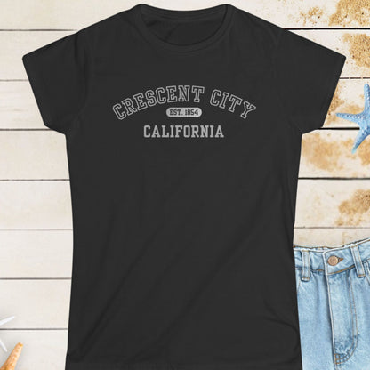 Black t-shirt with 'Crescent City, California' text on a wooden surface with starfish.