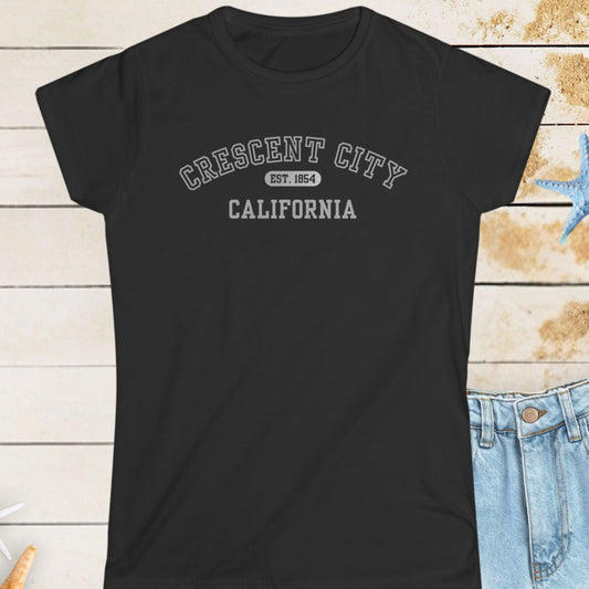 Black t-shirt with 'Crescent City, California' text on a wooden surface with starfish.