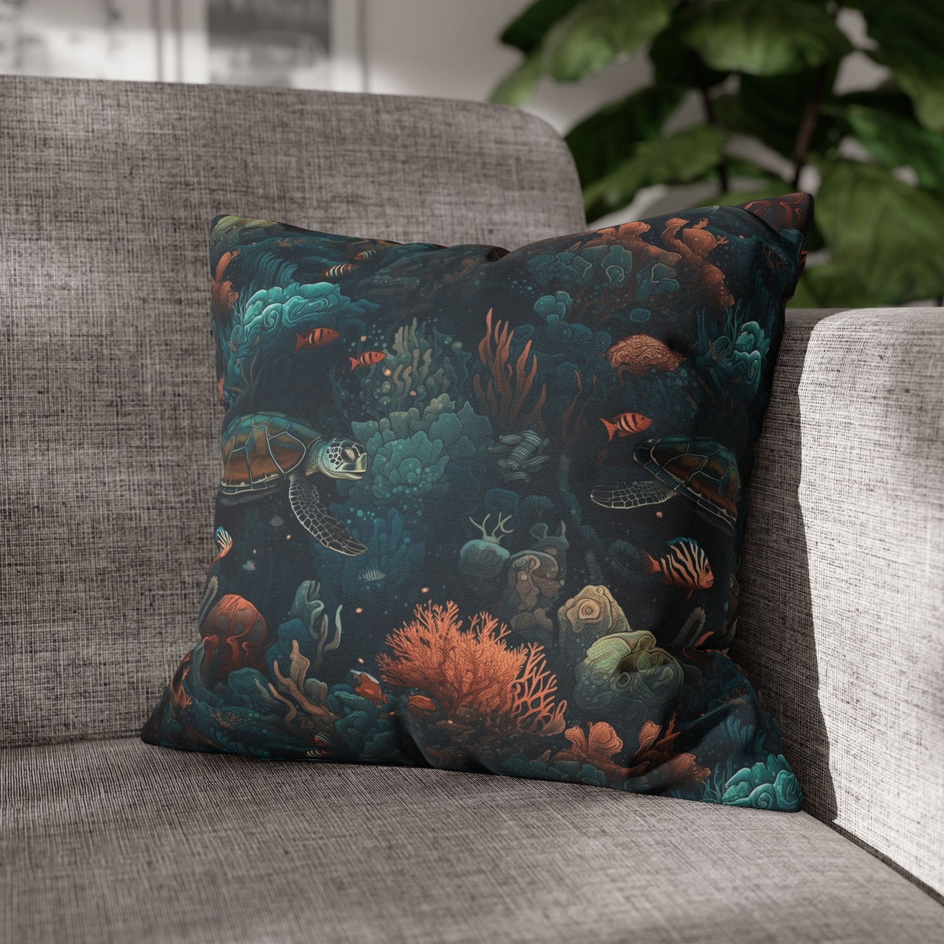 16" x 16" Decorative pillow with underwater scene with sea turtles on a gray couch.