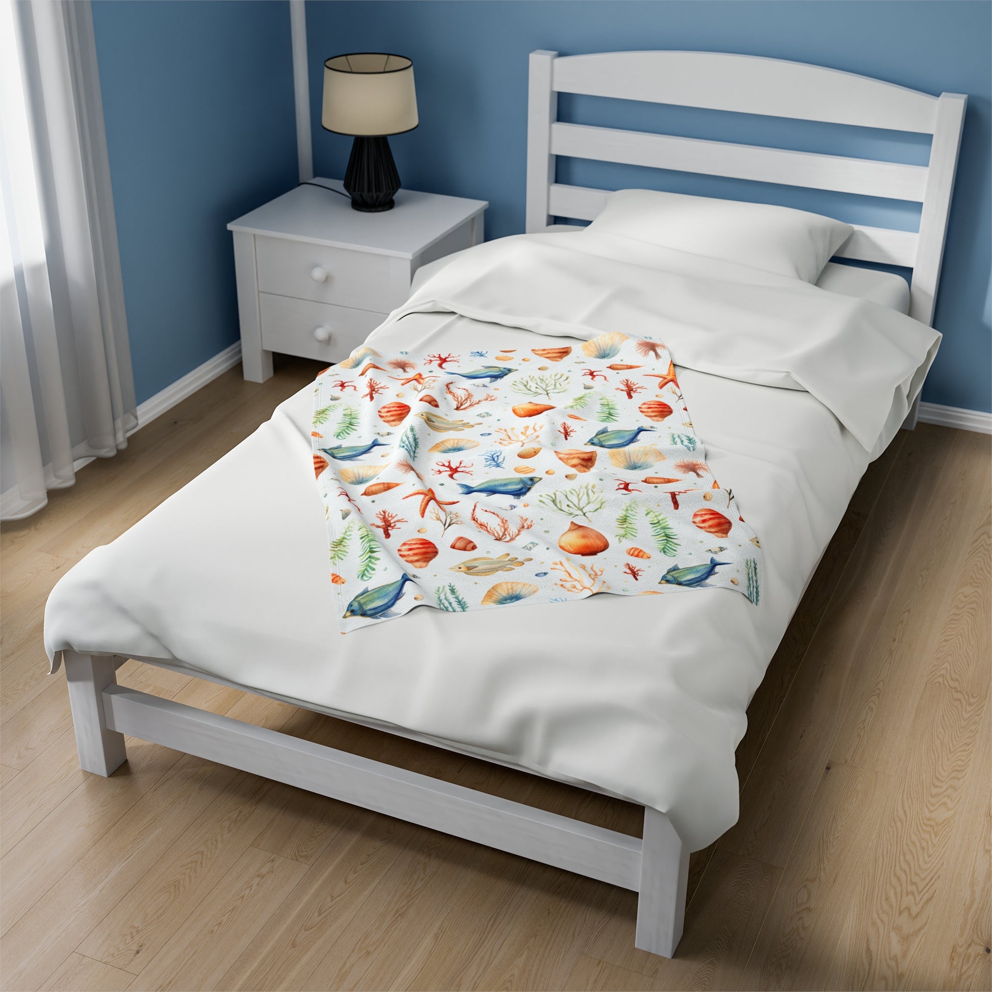 White blanket with fish, starfish, seashells and underwater plant life.