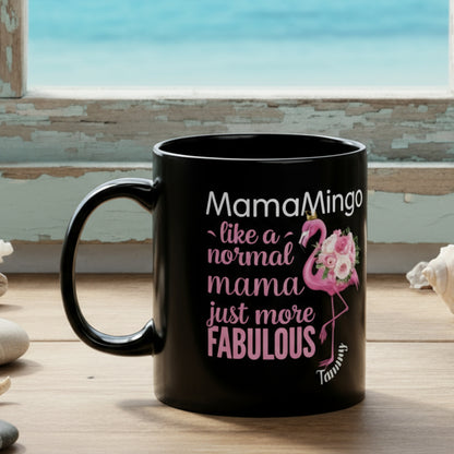 Black mug with pink flamingo design and text on a white background