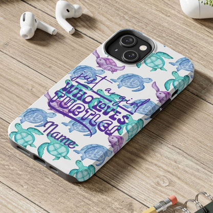 Phone case with sea turtle design and text on a wooden surface with laptop, earbuds, and notebook.