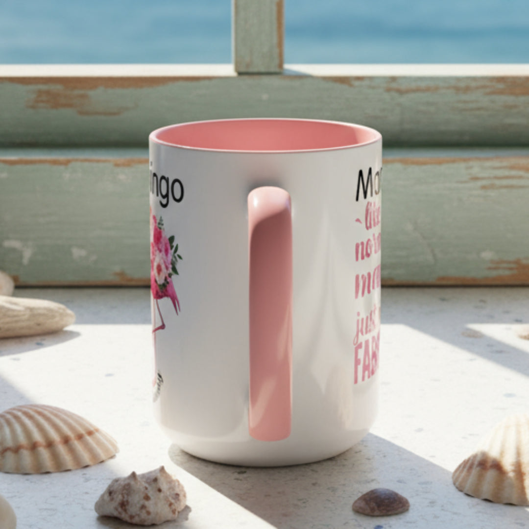 White mug with pink interior and handle, featuring text and a floral design on a white background.