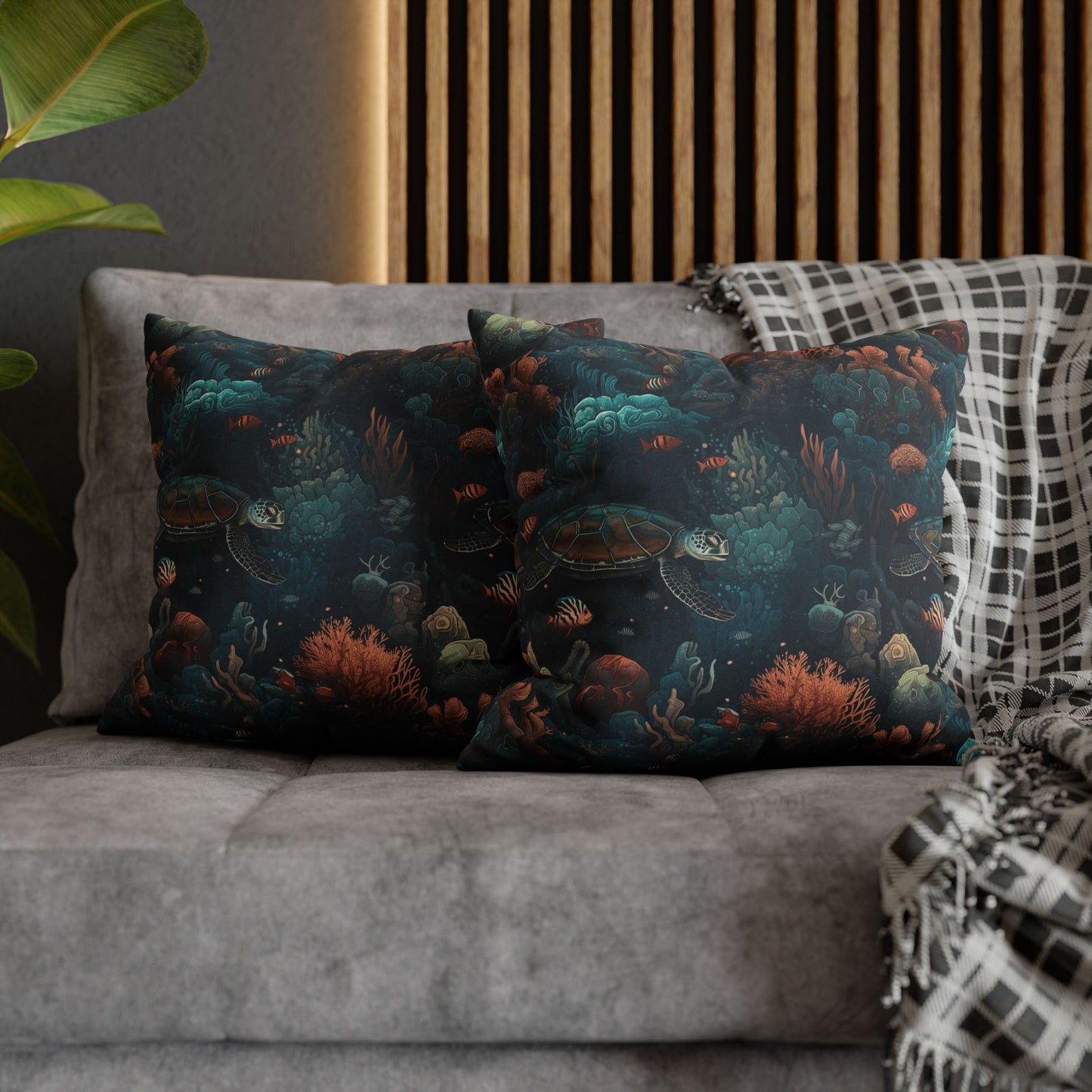 18" x 18"  two decorative pillows with underwater scene with sea turtles on a gray couch.