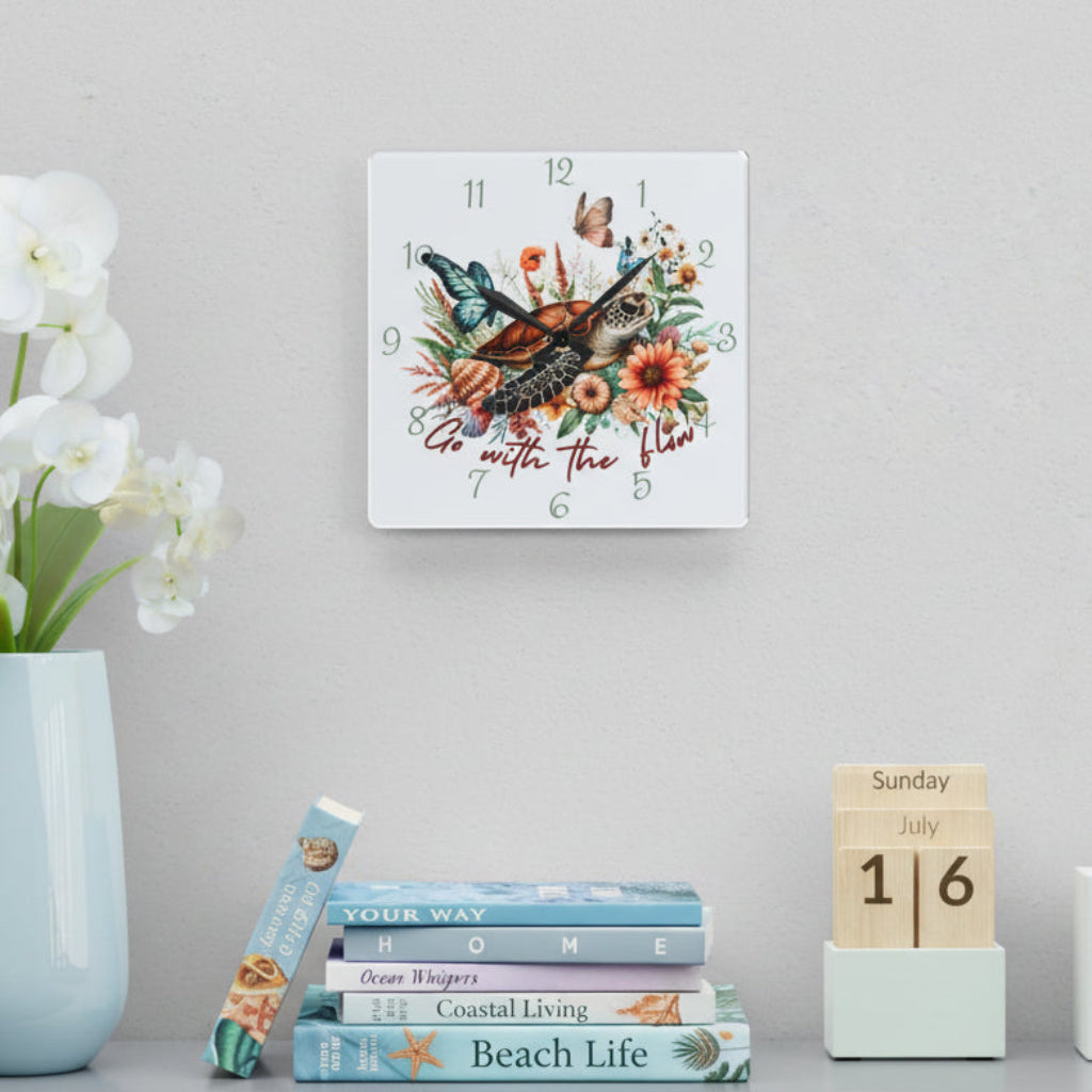 Decorative wall clock with floral and sea turtle design and text Go with the Flow.