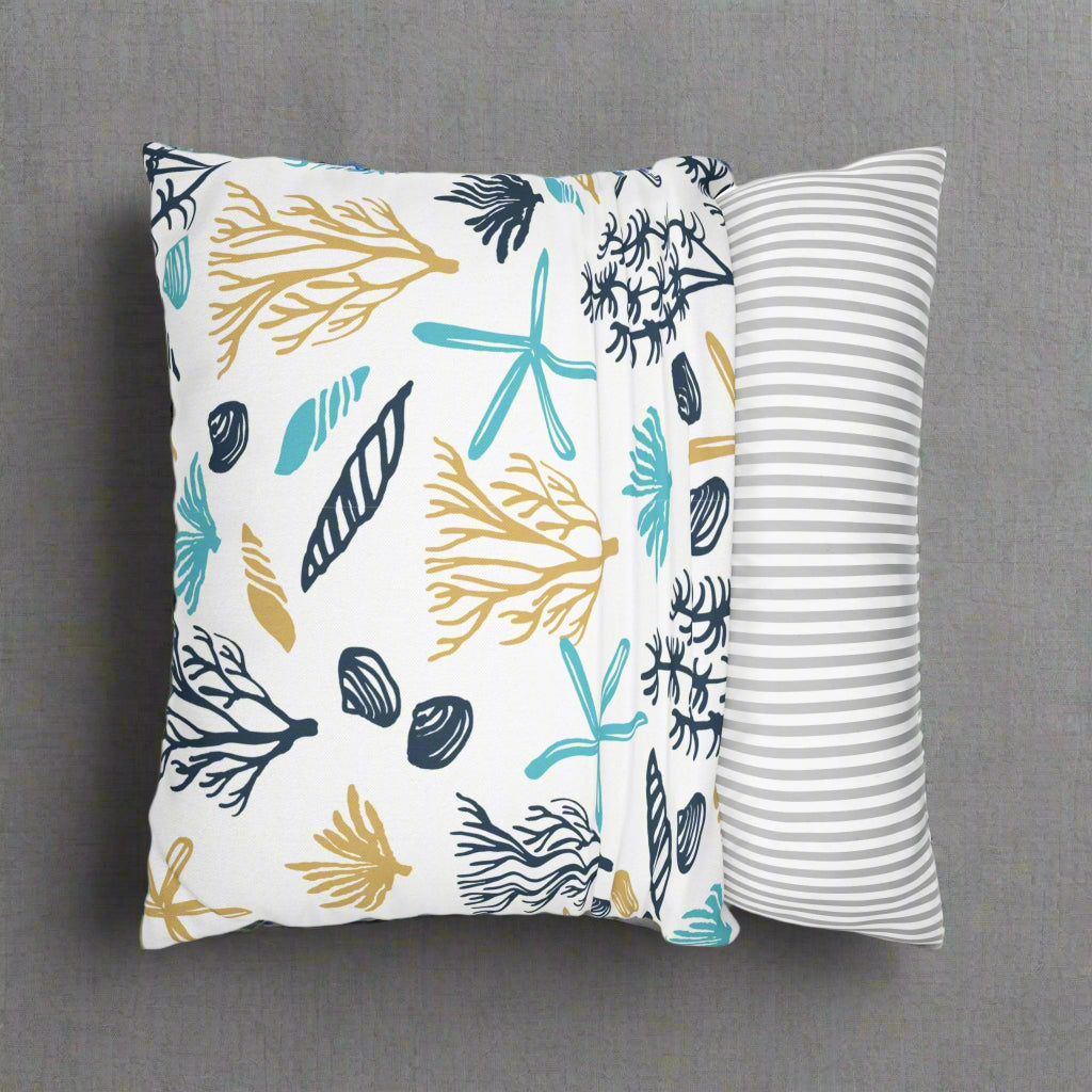 Two decorative pillows with beach-themed patterns.