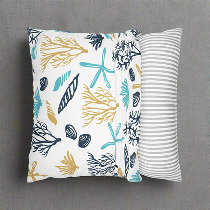 Two decorative pillows with beach-themed patterns.